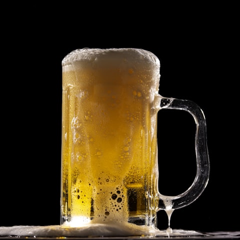 Branded Hops pint glass filled with golden beer